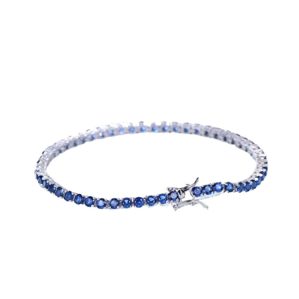 A silver bracelet with blue gemstones.